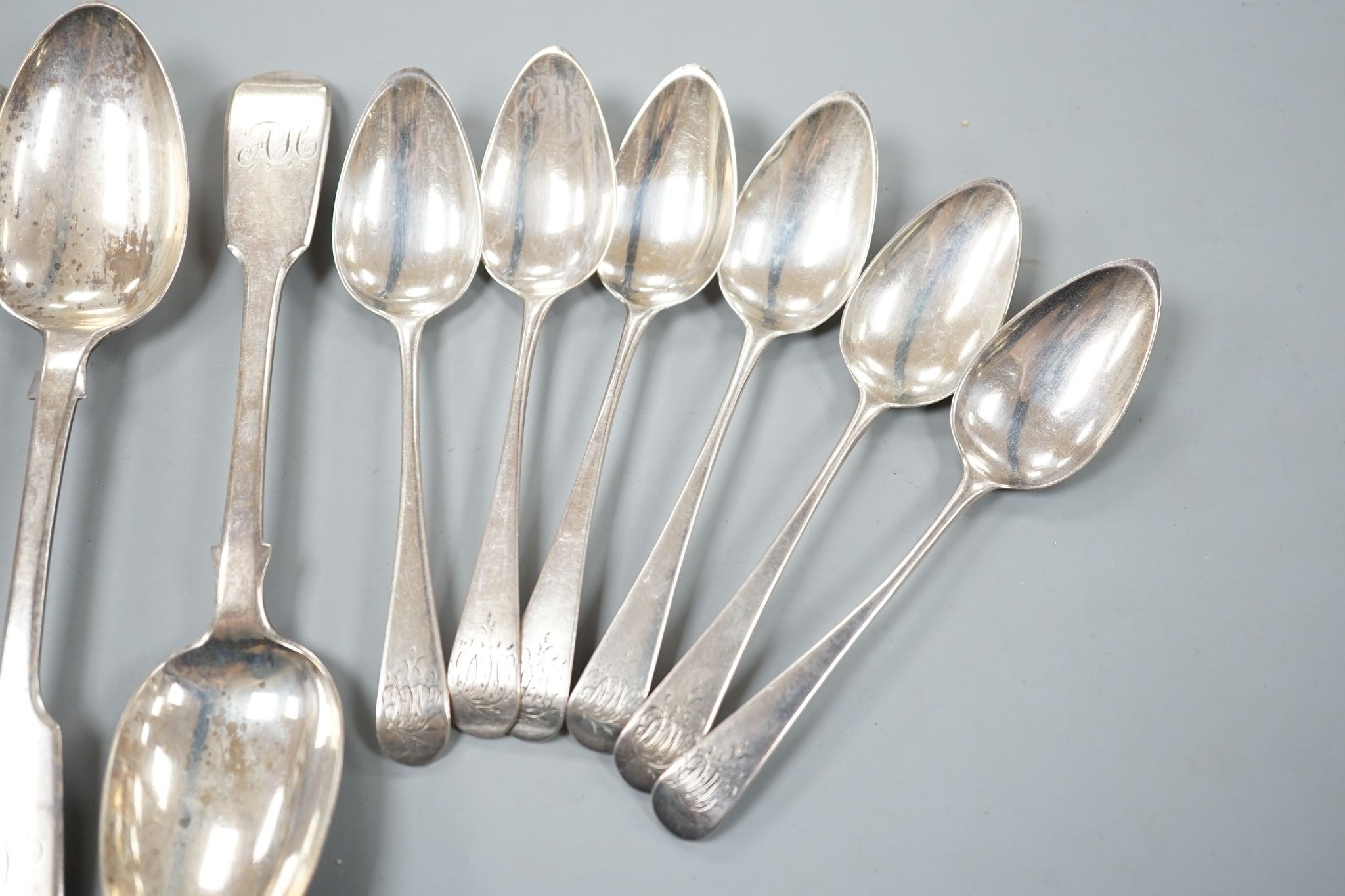 A set of six Victorian silver fiddle pattern dessert spoons, William Eaton, London, 1843, a set of six earlier silver teaspoons and a pair of George III silver sauce ladles, 14oz.